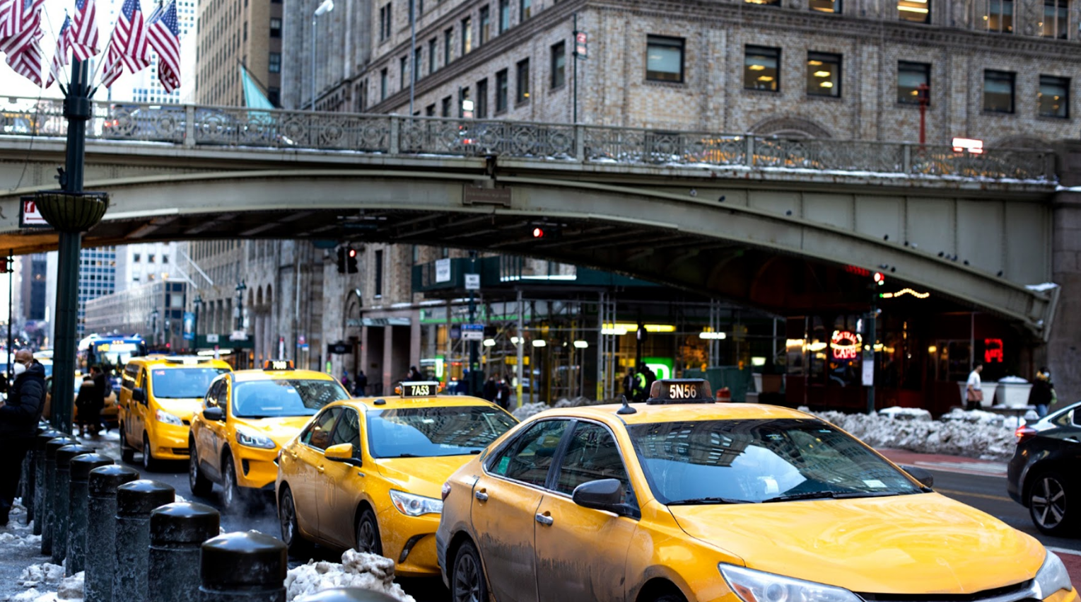 Cars lined up on a congested NYC street, illustrating circling for parking and traffic pollution